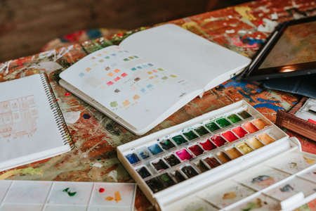 Close up of worktable with drawing and painting toolsの写真素材