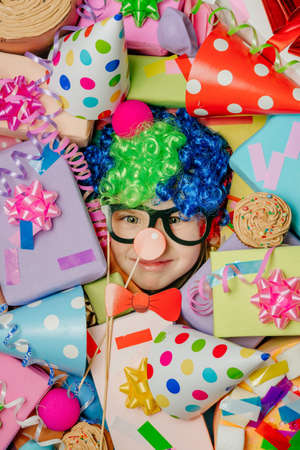 Little girl lying under plenty of present boxesの写真素材