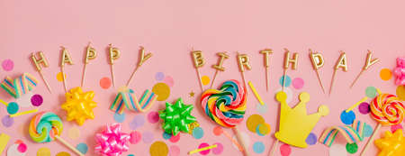 Horizontal panoramic banner with lollypops, confetti, bows on pink background