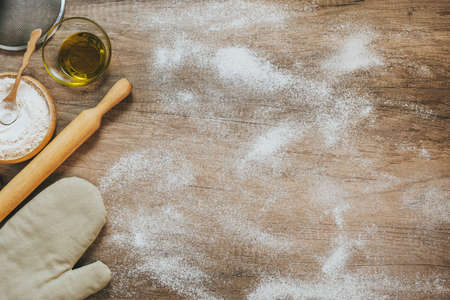 Ingridients for prepairing dough on a wooden table with blank spaceの写真素材