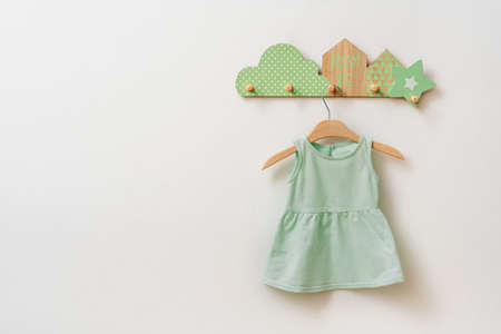 Kids dress made from organic cotton on the decorative rack on white background with blank space for text.の写真素材