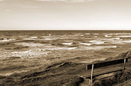 Bench by the ocean, sepiaの写真素材