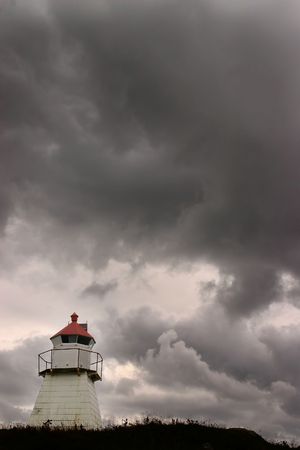Dark clouds and lighthouse in Norwayの写真素材