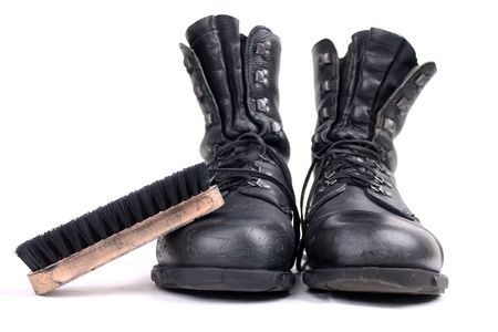 Boots and brush isolated on white backgroundの写真素材