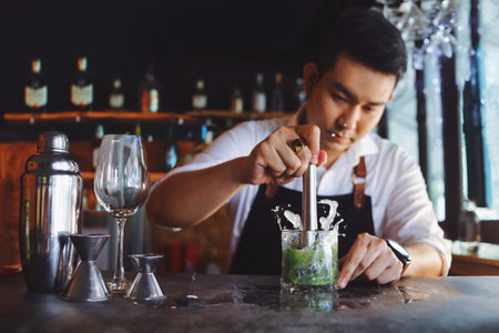 Bartender making cocktail at bar counter. Barman making cocktail.の写真素材