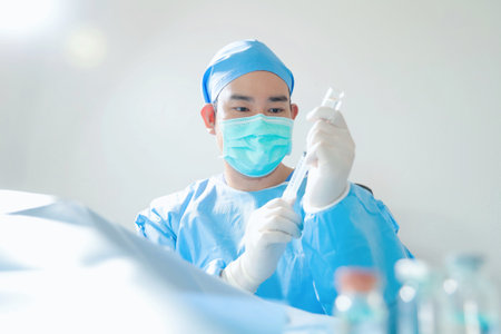 surgeon with surgical equipment in operating room,selective focus.の写真素材