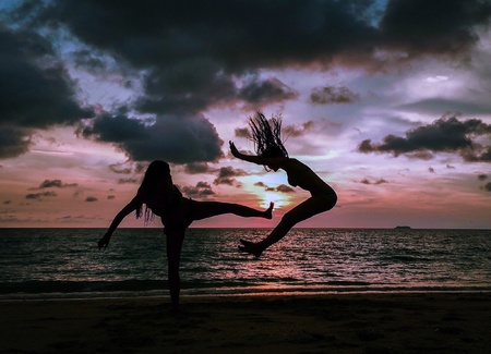 Kicking moment capturing of fun on sunset beachの素材