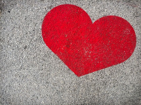 Red heart shaped painting on concrete, vintage, textured の素材