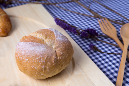 baked bread on wooden table background