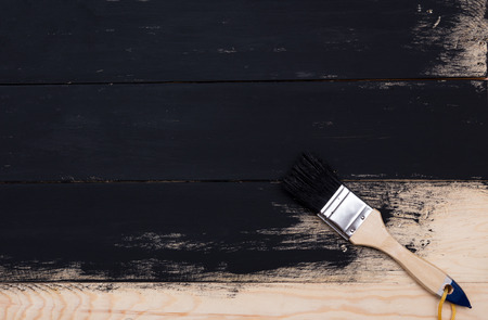 Painting natural wood with paint brushの写真素材