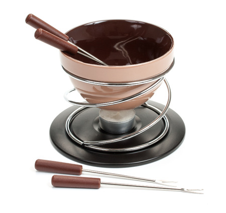 Brown set for fondue, for the preparation of chocolate fondue with a candle, isolated on a white background, close-up.の写真素材