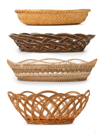 Set of wicker baskets, breadbaskets, bread-plates, dishes for food or fruits isolated on a white background. Low angle, side view, close up.の写真素材