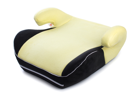 Safety booster seat for children, yellow car seat isolated on white background.の写真素材