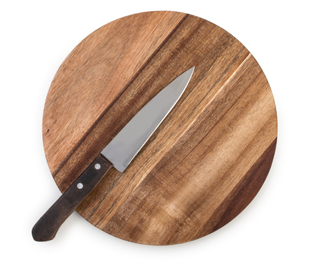 Chef knife on a round cutting board made from acacia wood isolated on white background, top viewの写真素材