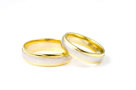 Two golden wedding rings on white background の写真素材