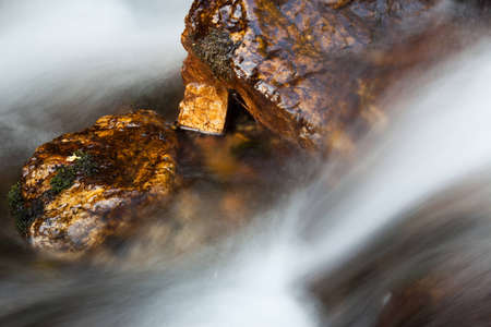 wet rock in blurred water motionの写真素材