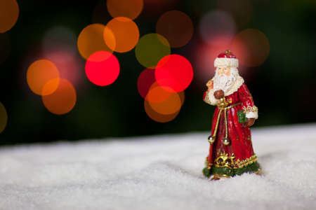 Saint Nicholas in snow with blurred lights in the backgroundの写真素材