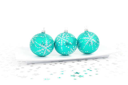 aqua baubles on a plate with stars on the backgroundの写真素材