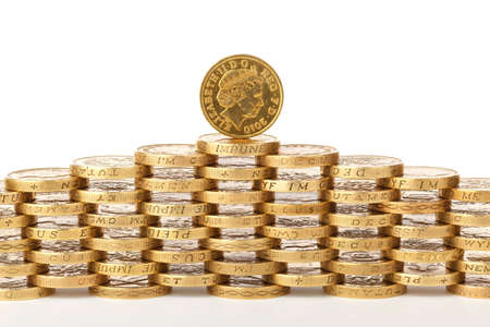 british one pound coins stacked on top of each otherの写真素材
