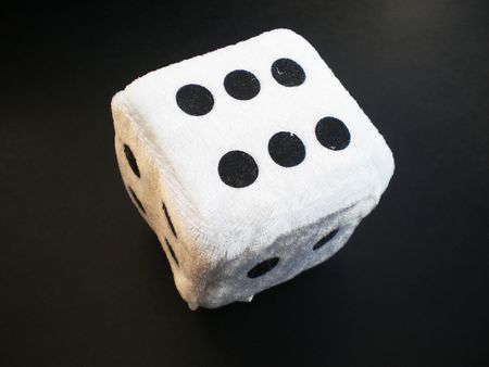 one white die isolated on black  の写真素材