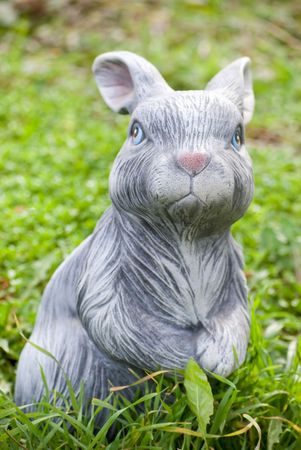 rabbit statue on green grass backgoundの写真素材