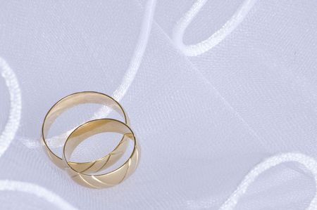 wedding golden rings over bridal veilの写真素材