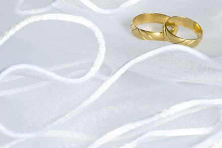 wedding golden rings over bridal veilの写真素材