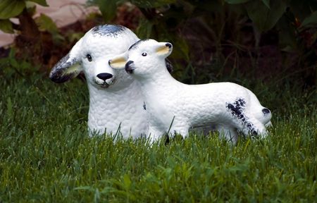 little lamb and sheep garden decorative statue on green grassの写真素材