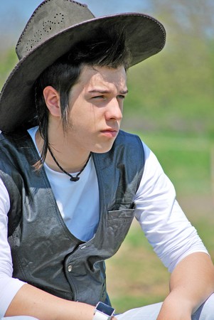 young man with cowboy hat portraitの写真素材