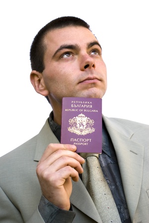 young business man holding his passport and looking up isolated on whiteの写真素材