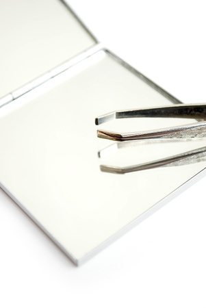 tweezers and mirror isolated on whiteの写真素材