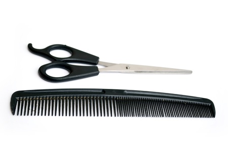 pair of scissors and comb isolated on white background
