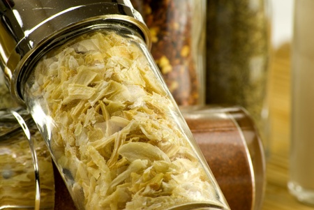 different spices in glass jars on wooden matの写真素材