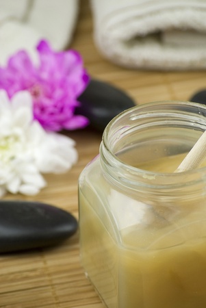 relaxing aroma of almond coconut vanilla milk and honey bath foam over wooden matの写真素材