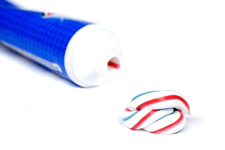 white red and blue squeezed toothpaste isolated on a white backgroundの写真素材