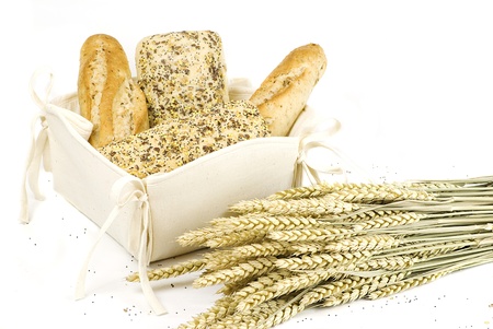 variety of different freshly baked bread in white cotton basket isolated over white background