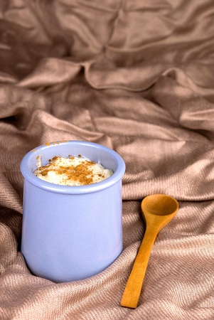 homemade rice with milk and cinnamon in a ceramic bowlの写真素材