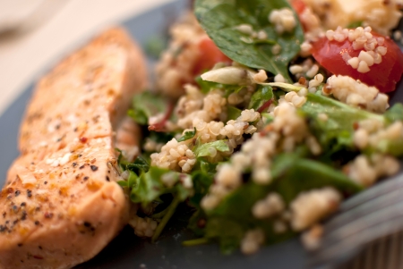 roasted salmon fillet with fresh green leaves salad and quinoaの写真素材