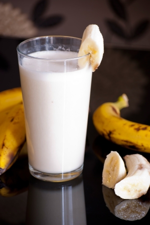 fresh banana smoothie and fruits on black backgroundの写真素材