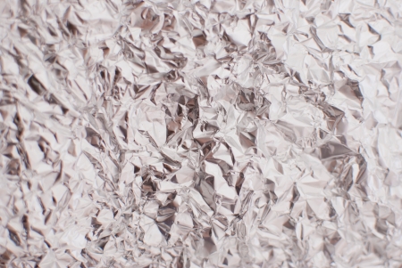 abstract silver rough wrinkle foil texture backgroundの写真素材