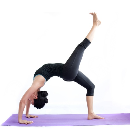 young brunette girl practising yoga isolated on white