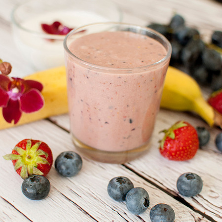 healthy organic fruit and nuts smoothie on wooden boardの写真素材