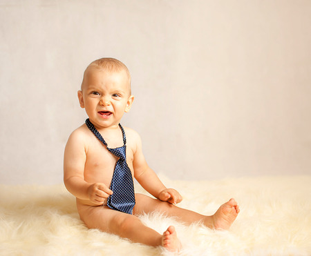 portrait of a happy caucasian adorable baby boy with tieの写真素材