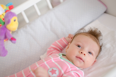 little cute baby girl playing in a cotの写真素材
