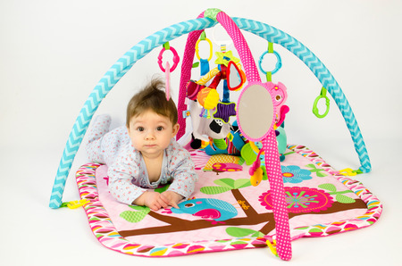 cute baby girld playing in an activity gymの写真素材
