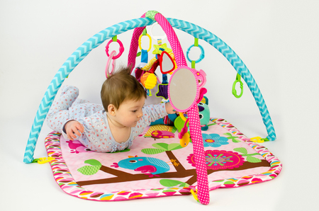cute baby girld playing in an activity gymの写真素材