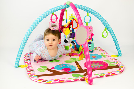 cute baby girld playing in an activity gymの写真素材