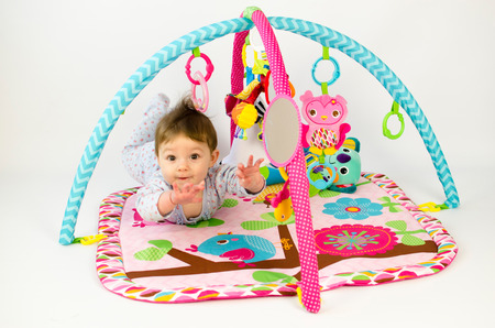 cute baby girld playing in an activity gymの写真素材