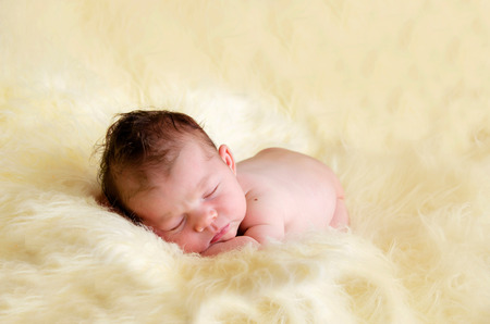 beautiful newborn baby girl sleeping peacefullyの写真素材