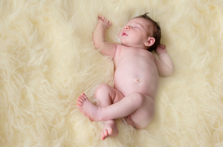 beautiful newborn baby girl sleeping peacefullyの写真素材